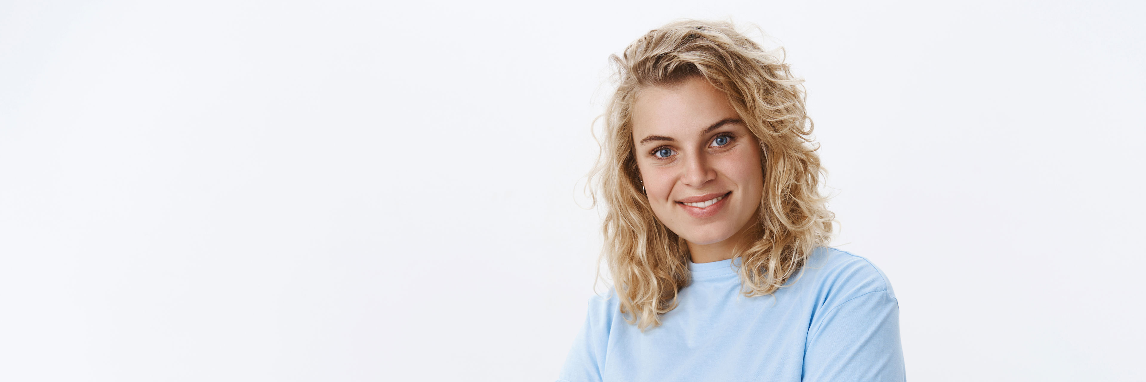 Ung kvinde med lyst hår og lyseblå t-shirt